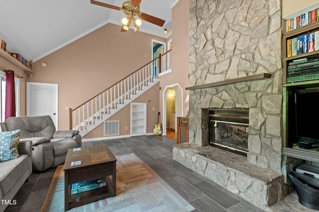 675 Anderson Creek Rd, Henderson, NC 27537 - living area featuring ceiling fan, high vaulted ceiling, a stone fireplace, visible vents, and stairway