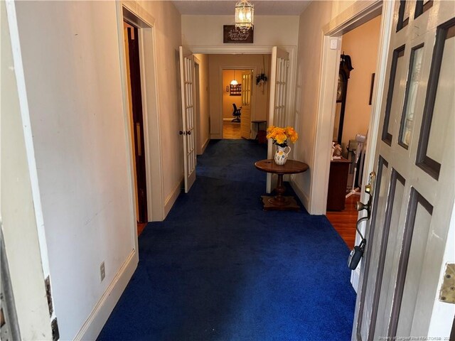 3903 Daytona Rd, Fayetteville, NC 28311 - corridor featuring baseboards and dark colored carpet