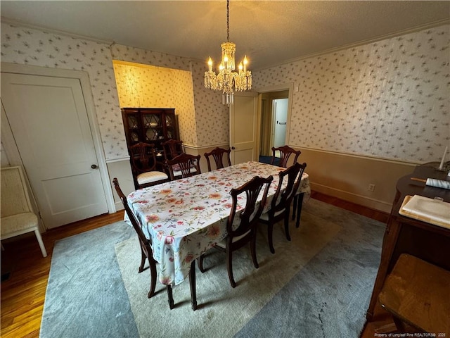3903 Daytona Rd, Fayetteville, NC 28311 - dining space with a chandelier, wainscoting, crown molding, wallpapered walls, and wood finished floors