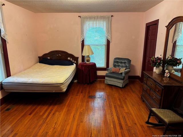 3903 Daytona Rd, Fayetteville, NC 28311 - bedroom featuring wood finished floors and a textured ceiling