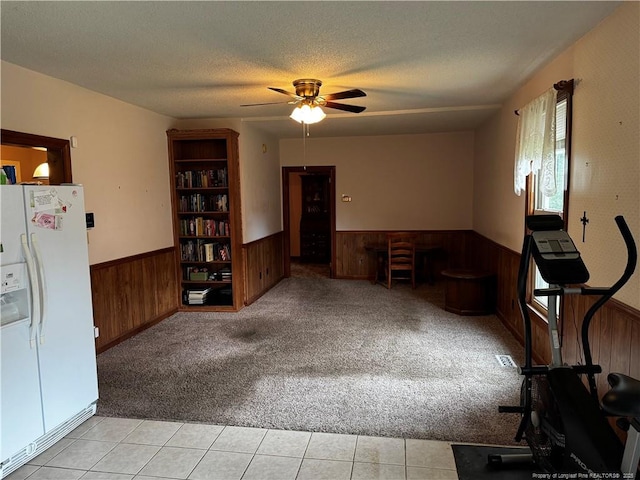 3903 Daytona Rd, Fayetteville, NC 28311 - empty room with a wainscoted wall, wood walls, light colored carpet, ceiling fan, and a textured ceiling