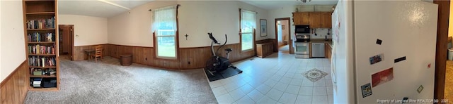 3903 Daytona Rd, Fayetteville, NC 28311 - hallway with a wainscoted wall, wooden walls, and tile patterned floors
