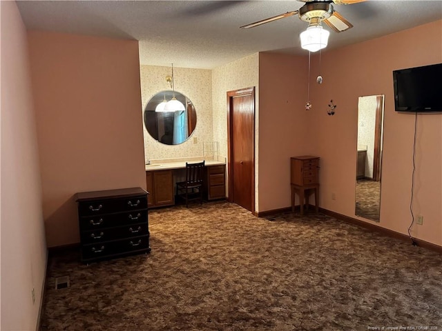 3903 Daytona Rd, Fayetteville, NC 28311 - unfurnished bedroom with wallpapered walls, dark carpet, a desk, baseboards, and ensuite bathroom