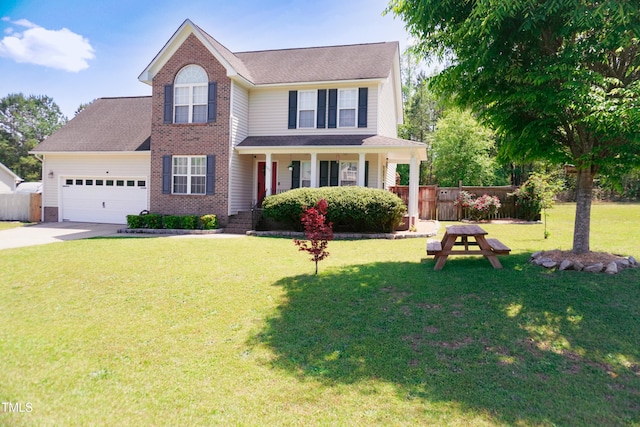 145 Ironwood Way, Raeford, NC 28376 - view of front of property with a front yard, brick siding, concrete driveway, an attached garage, and fence