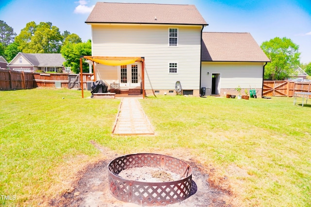 145 Ironwood Way, Raeford, NC 28376 - rear view of house with crawl space, a yard, a fire pit, and a fenced backyard