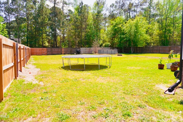145 Ironwood Way, Raeford, NC 28376 - view of yard featuring a trampoline and a fenced backyard