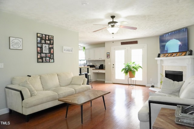 145 Ironwood Way, Raeford, NC 28376 - living area with a fireplace, wood finished floors, ceiling fan, and a textured ceiling