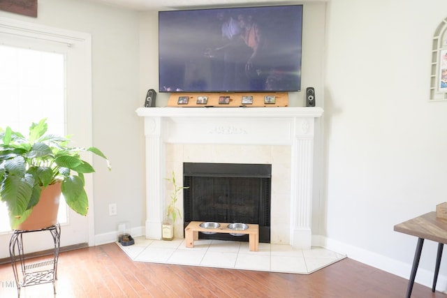 145 Ironwood Way, Raeford, NC 28376 - room details featuring a tiled fireplace, baseboards, and wood finished floors