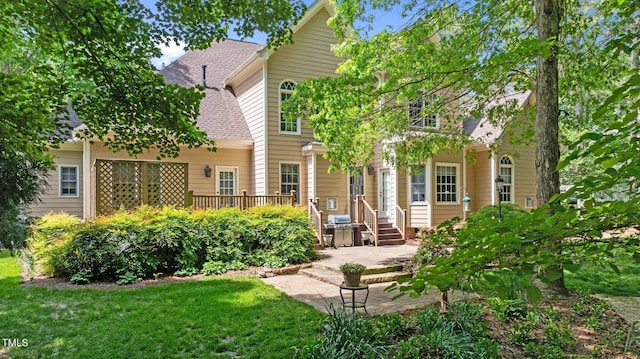 7212 Donneeford Rd, Wake Forest, NC 27587 - back of house featuring a shingled roof, a patio area, and a yard