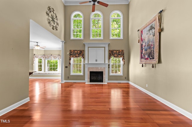 7212 Donneeford Rd, Wake Forest, NC 27587 - unfurnished living room featuring a ceiling fan, wood finished floors, baseboards, a high ceiling, and a tile fireplace