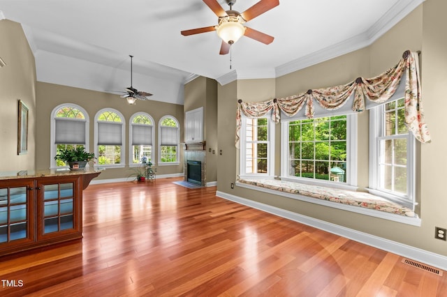 7212 Donneeford Rd, Wake Forest, NC 27587 - unfurnished living room with ceiling fan, healthy amount of natural light, wood finished floors, and ornamental molding