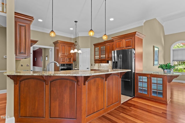7212 Donneeford Rd, Wake Forest, NC 27587 - kitchen featuring refrigerator with ice dispenser, oven, light wood finished floors, a kitchen breakfast bar, and glass insert cabinets