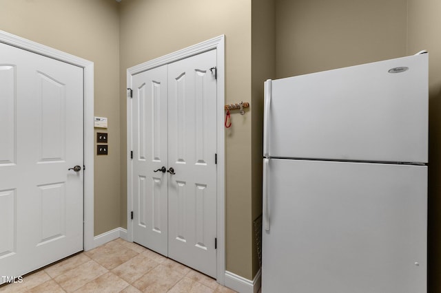 7212 Donneeford Rd, Wake Forest, NC 27587 - kitchen with freestanding refrigerator, baseboards, and light tile patterned floors
