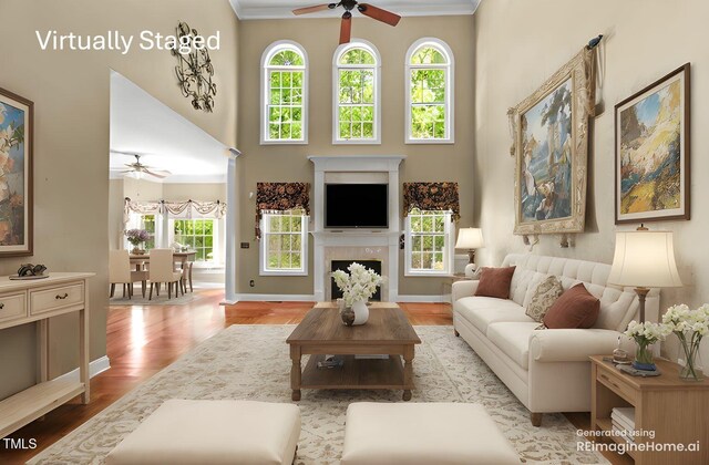 7212 Donneeford Rd, Wake Forest, NC 27587 - living area featuring a ceiling fan, wood finished floors, a high ceiling, baseboards, and a fireplace