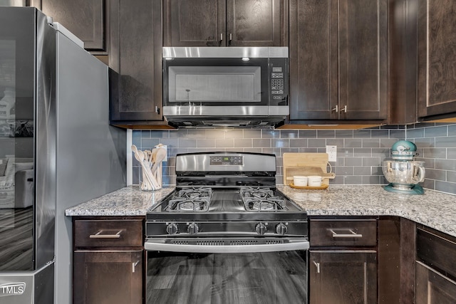 743 Hadstock Path, Zebulon, NC 27597 - kitchen with appliances with stainless steel finishes, dark brown cabinetry, and tasteful backsplash