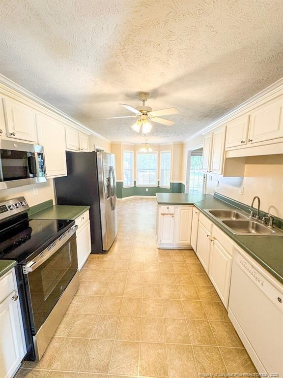 105 Little Rock Dr, Raeford, NC 28376 - kitchen featuring stainless steel appliances, a sink, ceiling fan, a peninsula, and ornamental molding