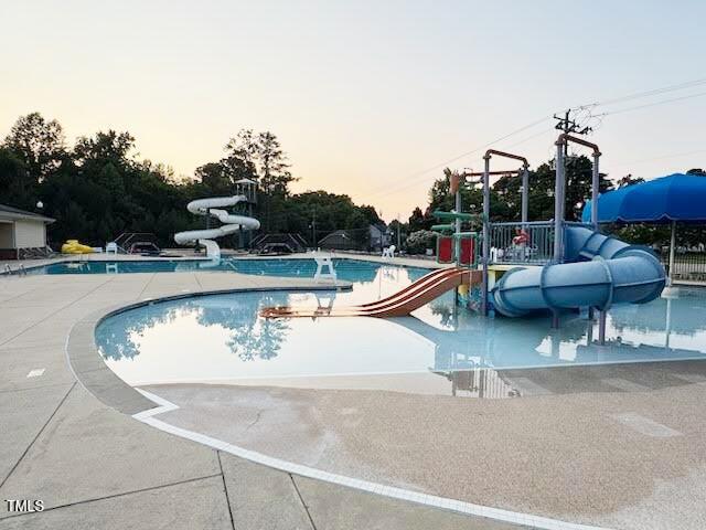 202 Verrazano Pl, Clayton, NC 27520 - community pool with a water slide and a patio area