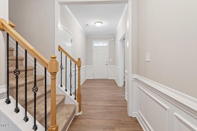 202 Verrazano Pl, Clayton, NC 27520 - entrance foyer with crown molding, wood finished floors, wainscoting, a decorative wall, and stairway