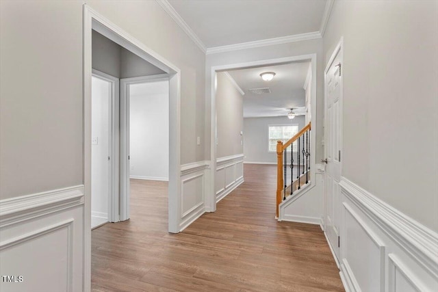 202 Verrazano Pl, Clayton, NC 27520 - hall featuring crown molding, light wood-type flooring, a decorative wall, and wainscoting