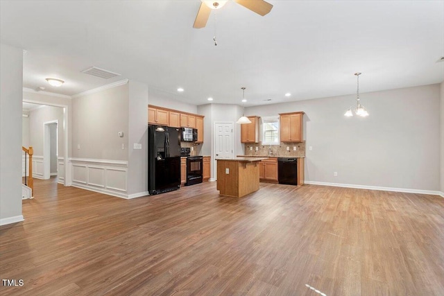 202 Verrazano Pl, Clayton, NC 27520 - kitchen with black appliances, open floor plan, a chandelier, light wood-style floors, and recessed lighting