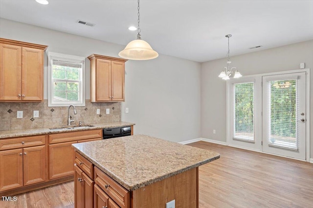 202 Verrazano Pl, Clayton, NC 27520 - kitchen with a sink, light wood-style floors, backsplash, a chandelier, and dishwasher