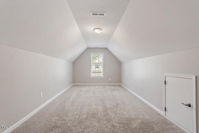 202 Verrazano Pl, Clayton, NC 27520 - bonus room featuring vaulted ceiling, carpet, and baseboards