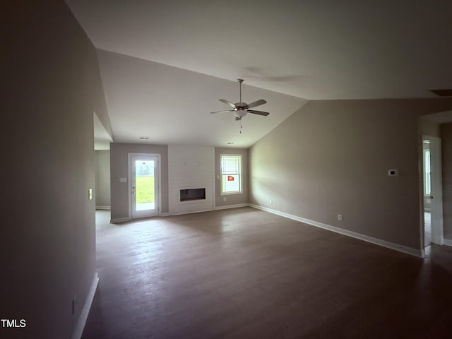 72 Ruskin Dr, Smithfield, NC 27577 - unfurnished living room featuring ceiling fan, baseboards, vaulted ceiling, dark wood-style floors, and a large fireplace