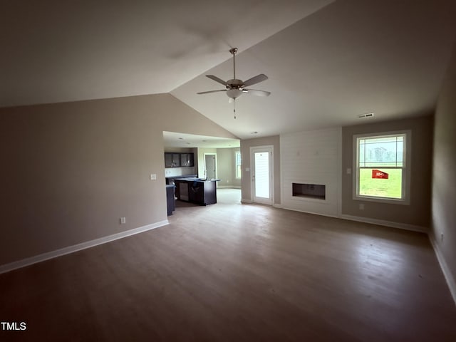 72 Ruskin Dr, Smithfield, NC 27577 - unfurnished living room with wood finished floors, ceiling fan, lofted ceiling, baseboards, and a fireplace
