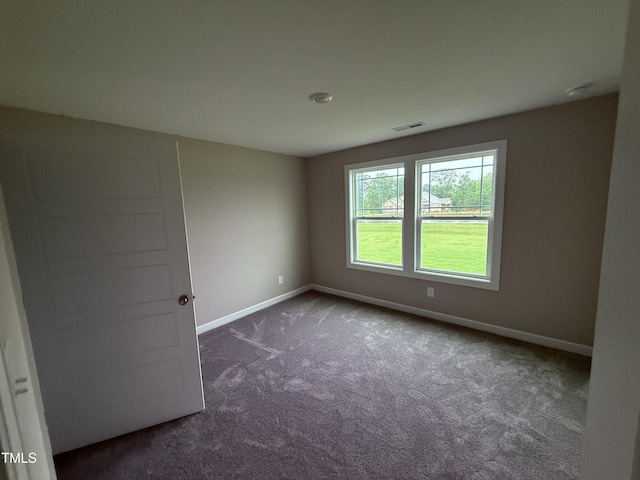 72 Ruskin Dr, Smithfield, NC 27577 - empty room with baseboards and dark colored carpet