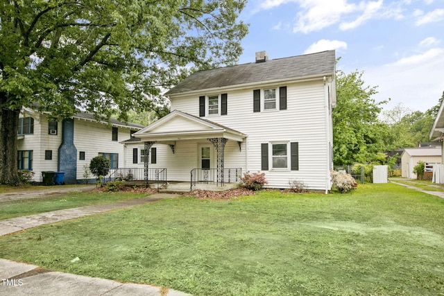 view of front of property featuring covered porch, a chimney, and a front lawn