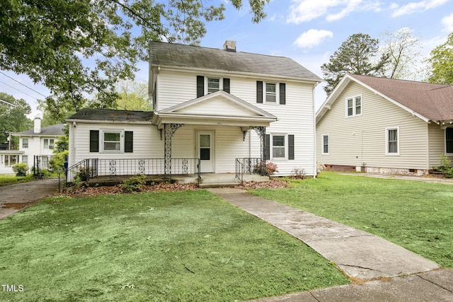 view of front of property featuring a porch, a chimney, and a front yard