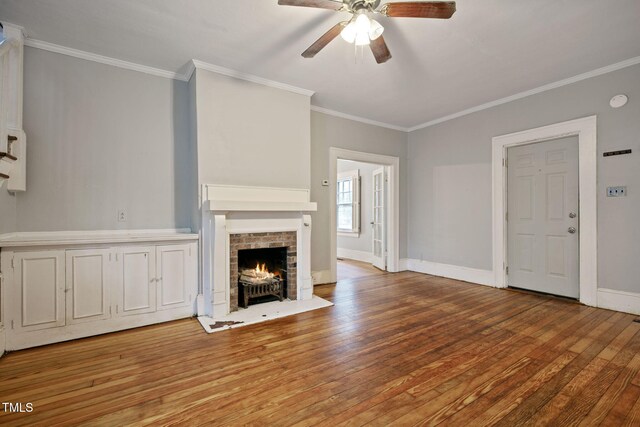 unfurnished living room featuring baseboards, ornamental molding, ceiling fan, and wood finished floors