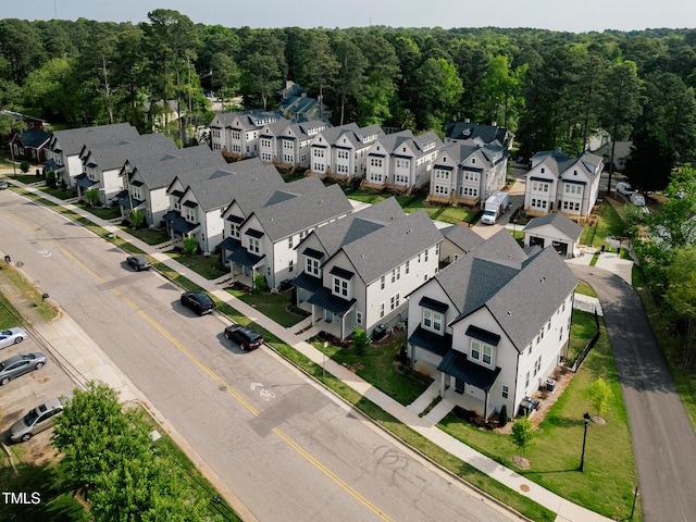 birds eye view of property featuring a residential view and a view of trees