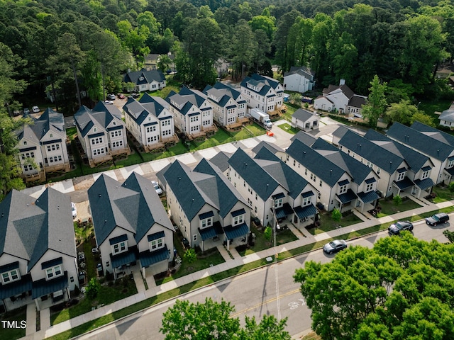 aerial view of residential area with a heavily wooded area