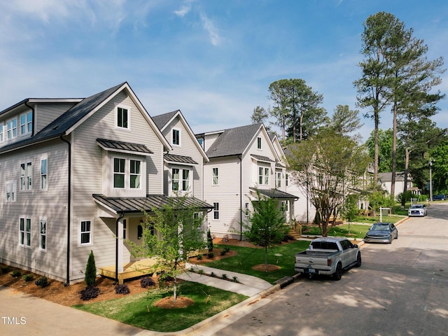 view of front of property featuring covered porch, metal roof, and a standing seam roof