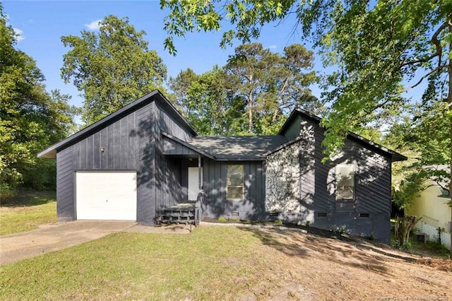 mid-century modern home with crawl space, driveway, a front yard, and a garage