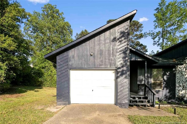 view of property exterior featuring a garage, a yard, and concrete driveway