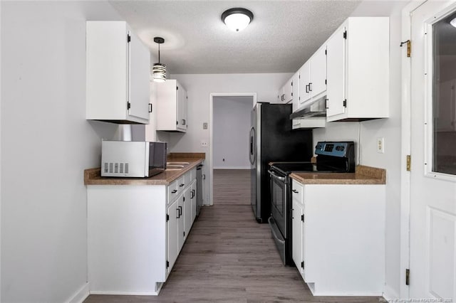 kitchen featuring a textured ceiling, light wood-style flooring, electric stove, white cabinetry, and under cabinet range hood