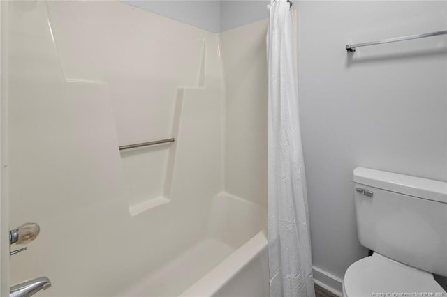 bathroom with shower / tub combo with curtain and toilet