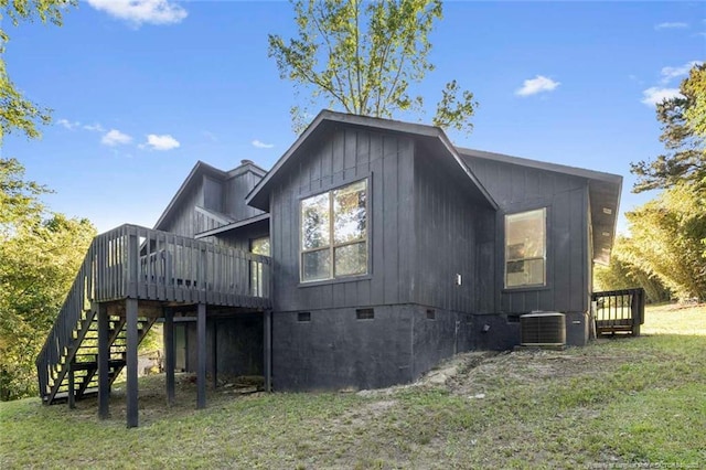 rear view of house with stairs, central AC, a deck, crawl space, and a yard