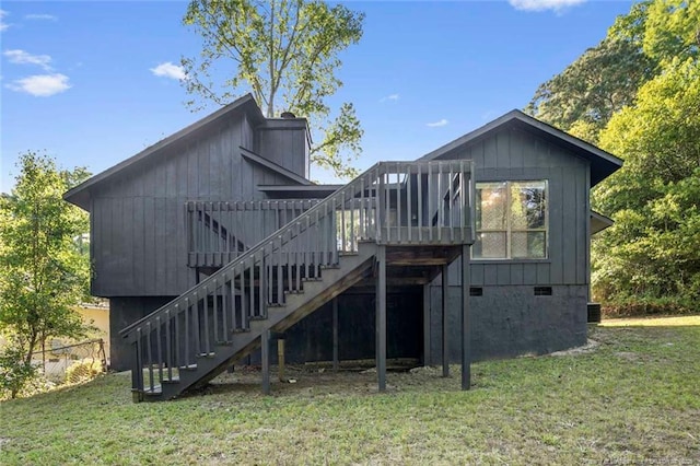back of house featuring fence, a deck, stairway, crawl space, and a yard