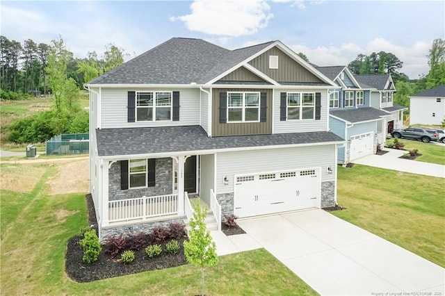 craftsman inspired home with board and batten siding, a porch, a shingled roof, driveway, and stone siding