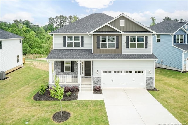 craftsman-style home featuring covered porch, an attached garage, board and batten siding, and roof with shingles
