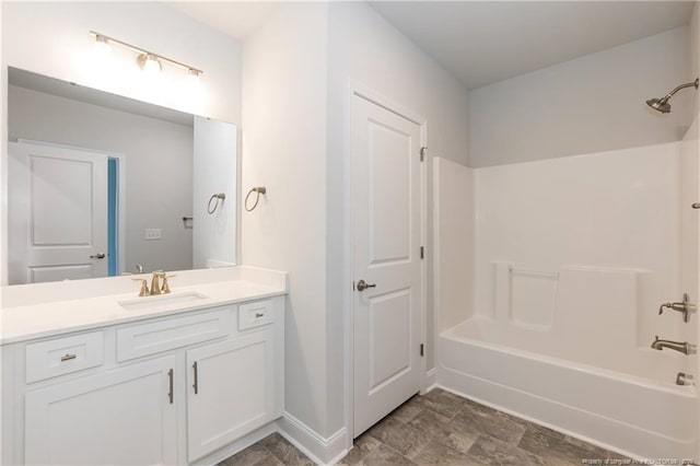 full bath with shower / washtub combination, vanity, and baseboards