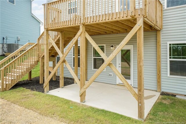 exterior space with stairway, central AC unit, a patio, and a wooden deck