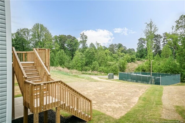 view of home's community with a wooden deck and stairway