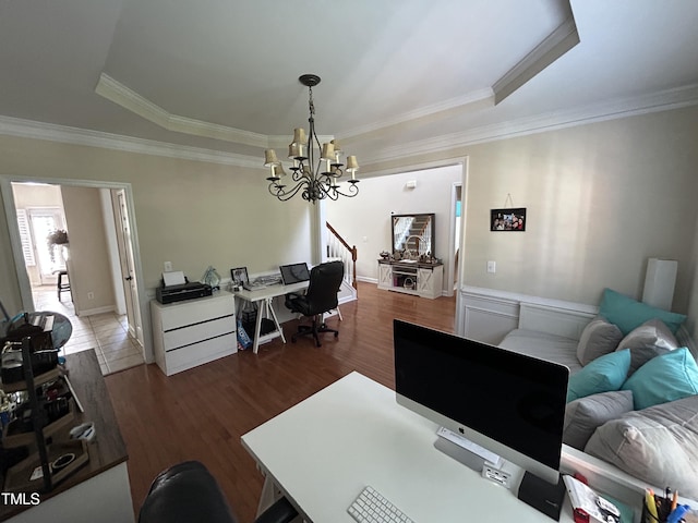 office area featuring a chandelier, wood finished floors, a tray ceiling, and crown molding