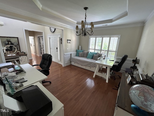 office area with dark wood finished floors, ornamental molding, a tray ceiling, a chandelier, and wainscoting