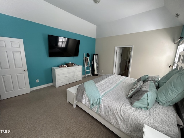 carpeted bedroom featuring vaulted ceiling and baseboards