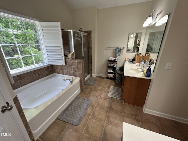 bathroom featuring a bath, tile patterned flooring, a stall shower, vanity, and baseboards